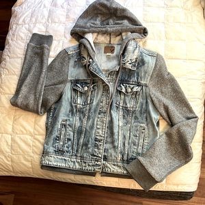 Distressed denim long sleeve coat.  Sleeves and good are sweatshirt material.